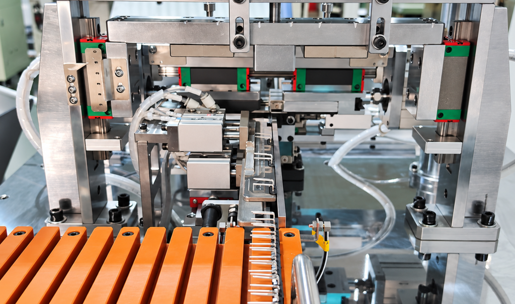 Transistor leads being bent to 90 degrees inside an automatic lead forming machine